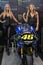 Beautiful Monster Energy girls pose with the motorcycle at Belgrade Car and Motor Show