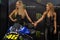 Beautiful Monster Energy girls pose with the motorcycle at Belgrade Car and Motor Show