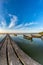 Beautiful morning landscape with boats on the lake anchored to the pier and wood bridges at sunrise