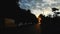 Beautiful morning sunrise in the city street in distant road on the horizon. The foreground in silhouette. Cars are