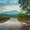 Beautiful morning view with the sun shining with stunning colors and water reflection in the rice fields in North Bengkulu,