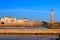 Beautiful morning view of Venetian Lighthouse, Firka castle walls and piers of Old Venetian harbour of Chania, Crete