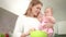 Beautiful mother cooking with daughter. Mom with child on kitchen