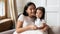 Beautiful mother cuddles adorable preschool daughter happy family portrait