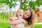 Beautiful mother with cute little baby boy having fun outdoors. Portrait of mom with fun child smiling in green summer garden.