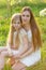 Beautiful mother and daughter in a blooming garden in the spring