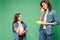 Beautiful mother and daughter talking on vintage telephones isolated