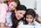 Beautiful mother with her daughters listening to music at home.