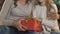 Beautiful mother hugging her adorable daughter, preparing presents for father