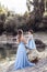 Beautiful mother with small daughter in blue indentical dresses