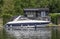 A beautiful motor cruiser cruising on the Thames at Henley-on-Thames in Oxfordshire