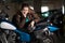Beautiful motorcycle brunette woman with a classic motorcycle, brown lather jacket