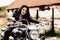Beautiful motorcycle brunette woman with a classic motorcycle c