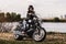 Beautiful motorcycle brunette woman with a classic motorcycle c