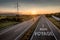 Beautiful Motorway with a Single Car at sunset with motivational message Bon Voyage