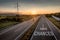 Beautiful Motorway with a Single Car at sunset with motivational message Take Chances