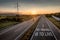 Beautiful Motorway with a Single Car at sunset with motivational message To Travel Is To Live