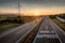 Beautiful Motorway with a Single Car at sunset with motivational message Travel Is Happiness