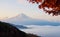 Beautiful Mount Fuji with sea of mist and red maple leaves in th