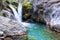 A beautiful mountain gorge with a river and a waterfall