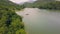 Beautiful mountain lake with clear green water and large stones on shore aerial view. Landscape view from flying drone