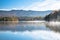 Beautiful mountain lake covered with morning fog during the autumn colour season