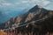 Beautiful mountain landscape with blue coudy sky. Suspension extreme bridge at Rosa Peak top