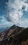 Beautiful mountain landscape with blue coudy sky. Suspension extreme bridge at Rosa Peak top. Vertical