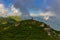 Beautiful mountain landscape at Caucasus mountains with woman standing far on the ridg