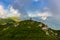 Beautiful mountain landscape at Caucasus mountains with woman standing far on the ridg