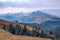 A beautiful mountain landscape with fir trees, mountain peaks and a fabulous sky