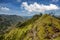 Beautiful mountain landscape, green hills and blue sky with clouds. Small peak of Adam, Sri Lanka island