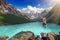 Beautiful mountain landscape with lake and jumping man