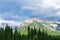 Beautiful mountain landscape with a rainbow cascading across the peak