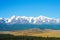 Beautiful mountain landscape. Snow-capped mountains, steppe and conifers