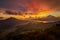 Beautiful mountain landscape during sunrise. Hills, Batur volcano and lake. Scenic panoramic view. Colorful sky with clouds. Foggy