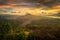 Beautiful mountain landscape during sunrise. Hills, Batur volcano and lake. Scenic panoramic view. Colorful sky with clouds. Foggy