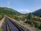 Beautiful mountain narrow-gauge railway road, rails in the mountains of the Carpathians passing through the forest in