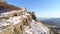 Beautiful mountain panorama with rock ledges and snow. Shot. Rock with small amount of snow on background of mountain