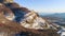 Beautiful mountain panorama with rock ledges and snow. Shot. Rock with small amount of snow on background of mountain