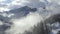 Beautiful mountain peak in cloudy haze from takeoff drone. Winter mountain and forest in misty haze aerial landscape. Highlands an