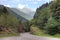 Beautiful mountain road landscape blue sky summer travel empty highway nature asphalt green forest rural way trees scenery swiss