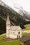 Beautiful mountain scenery in the Alps with fresh green meadows in bloom on a beautiful sunny day in springtime. Dolomiti montains