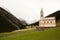 Beautiful mountain scenery in the Alps with fresh green meadows in bloom on a beautiful sunny day in springtime. Dolomiti montains