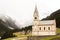 Beautiful mountain scenery in the Alps with fresh green meadows in bloom on a beautiful sunny day in springtime. Dolomiti montains