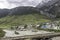 Beautiful mountain scenery. River, valley, snow, blue sky, white clouds. In-depth trip on the Sonamarg Hill Trek in Jammu and