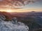 Beautiful mountain valley with a small hill peaks in sunset rays