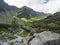 Beautiful mountain valley Smutna dolina with rock boulders, footpath trail, dwarf scrub pine and green mountain peaks