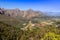 Beautiful mountainous landscape from a moving car driving on a tar road, Cape Town