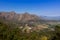 Beautiful mountainous landscape from a moving car driving on a tar road, Cape Town